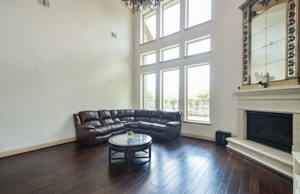 A wall of windows and soaring vaulted ceiling embrace this spectacular living area with built-in, corner fireplace as the star of the show, at holiday time or anytime!