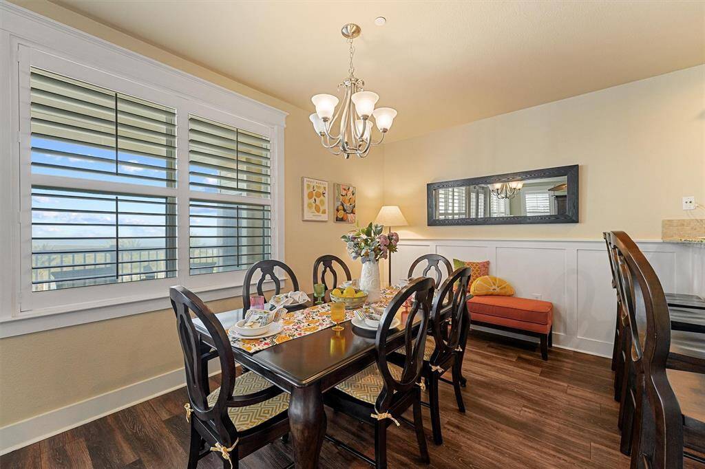 Enjoy incredible natural light and scenic Gulf views from the comfort of your dining room, surrounded by charming wainscoting and classic plantation shutters.