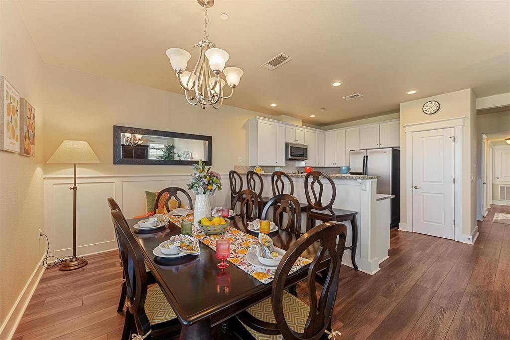 Set just off the kitchen, this beautifully furnished dining space features a warm, coastal feel with designer touches and bar seating for extra guests.