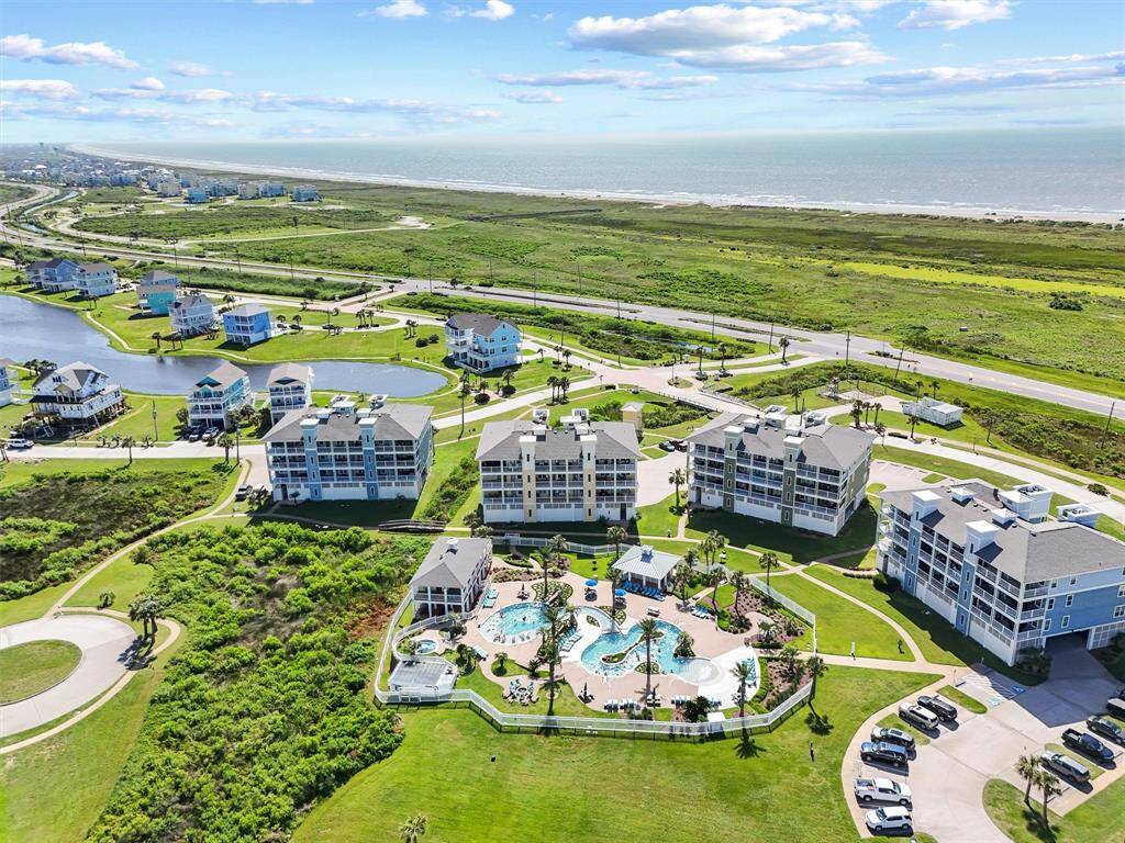 Aerial views showcase the thoughtfully planned layout of this beachside retreat—offering walkable streets, open space, and prime access to the shoreline.