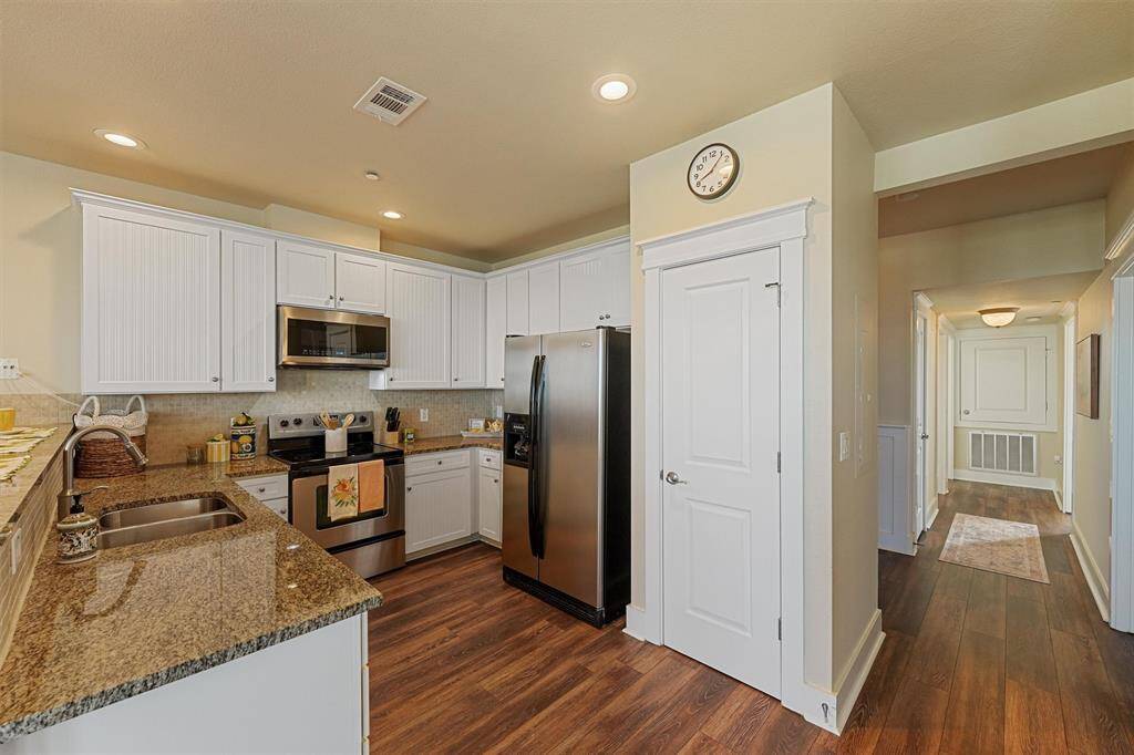 The kitchen layout maximizes prep space with extended counters, a double sink, and thoughtful finishes throughout.