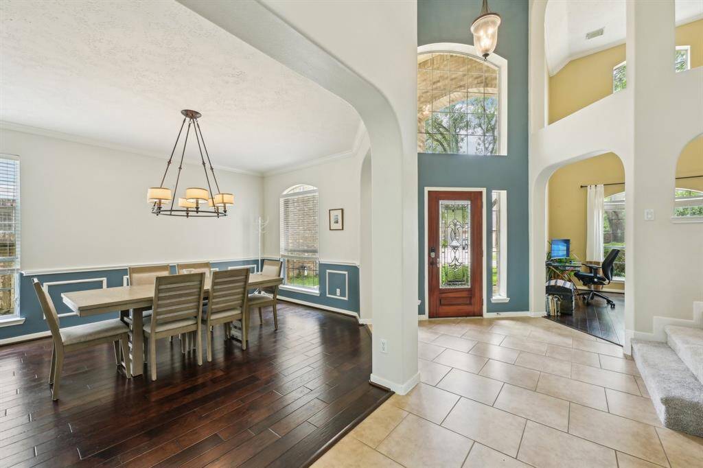 Inviting 2 story entry & study, open formal dining with wood floors