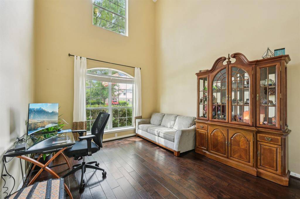 Study features soaring ceilings and wood floors, located on the 1st floor