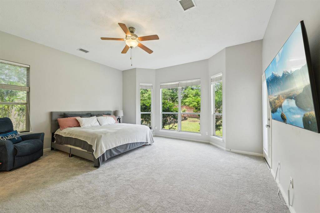 Primary bedroom is down stairs with door to covered back patio.