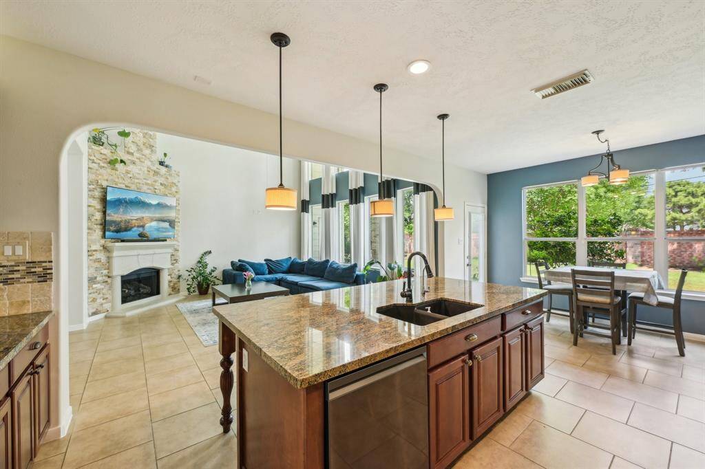 Chef's dream kitchen features smart appliances, granite counters, under mount lighting, and walk-in pantry!