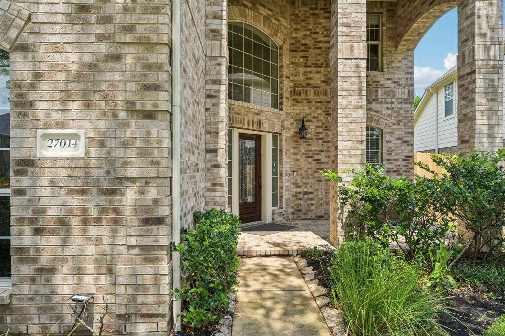 Lovely covered front porch to welcome your guests, and water views from lake across the street.