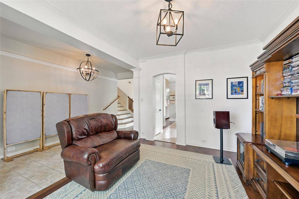 The formal dining room features an elegant arched entryway leading to the kitchen.