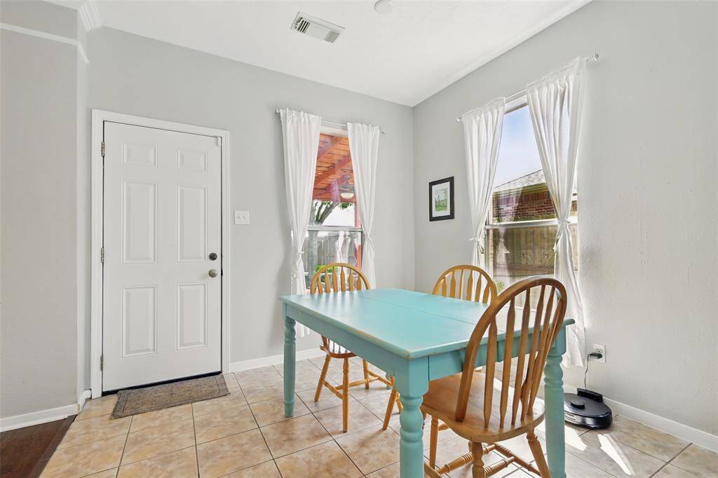 The breakfast room features a door that opens directly onto the back patio.