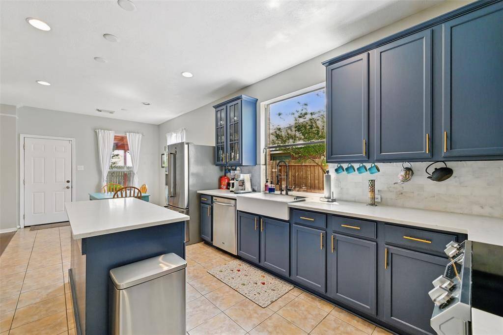 A kitchen featuring a spacious window and a charming farmhouse sink.