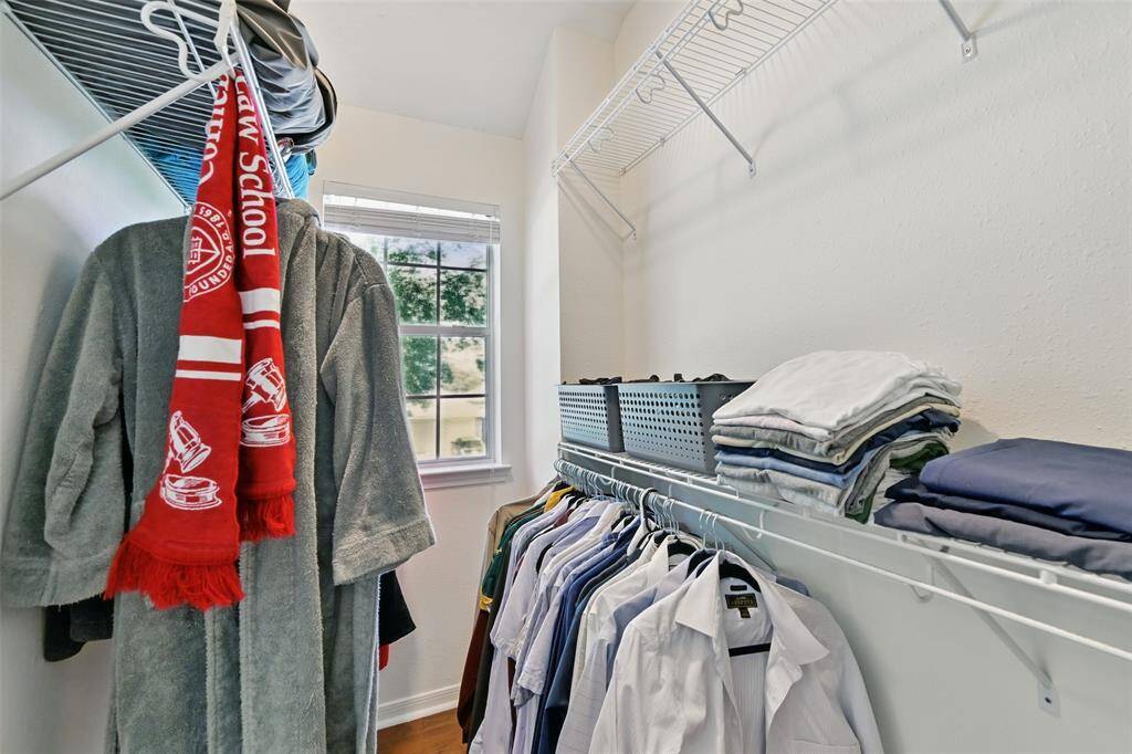 Primary closet featuring a window and equipped with storage racks for optimal organization.