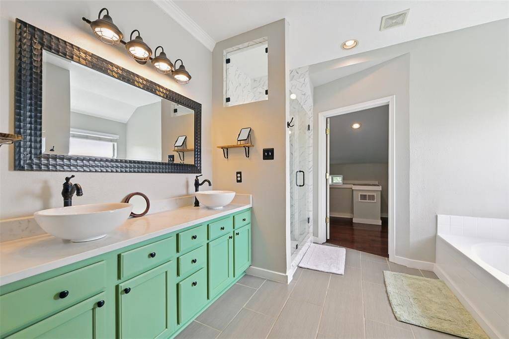 A luxurious ensuite featuring double sinks and elegant quartz crystal countertops.