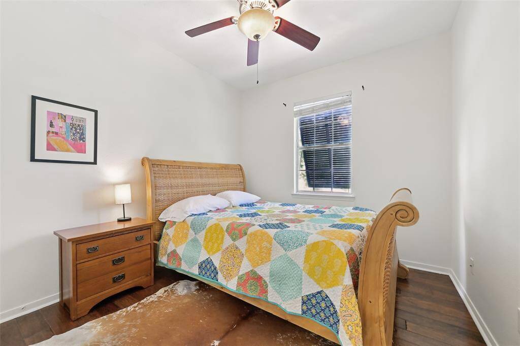 Bedroom three features a ceiling fan paired with a sleek light fixture, combining functionality and style.