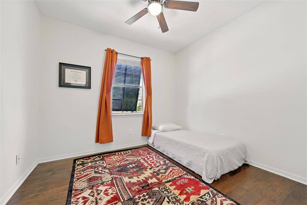 Bedroom Four features a ceiling fan paired with an elegant light fixture, offering both comfort and style.