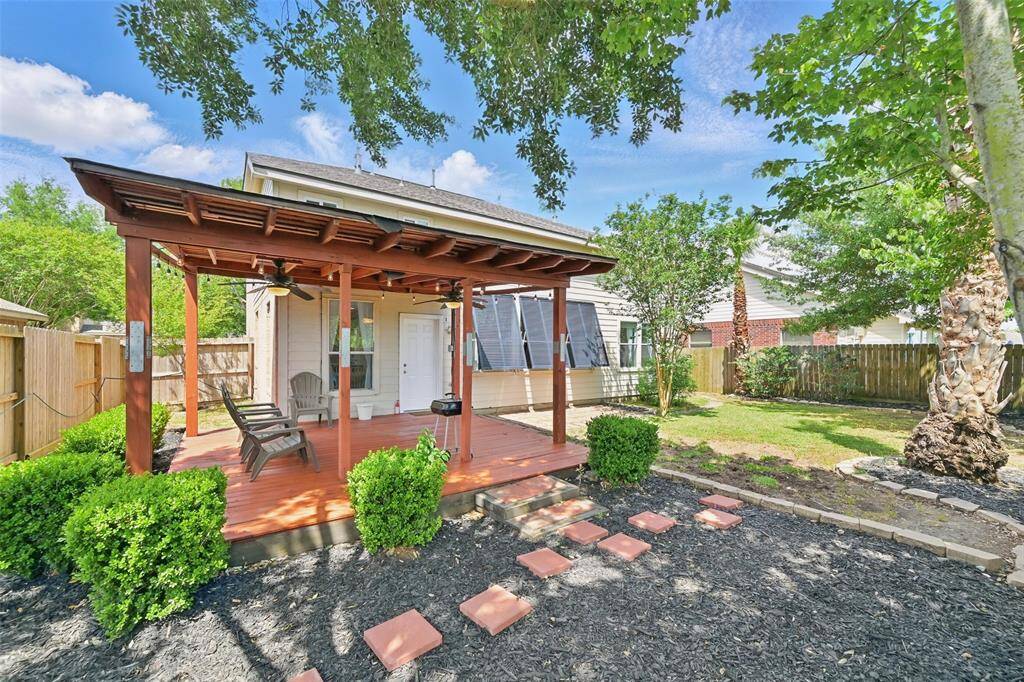Unwind on the covered patio, beautifully nestled amidst lush landscaping.