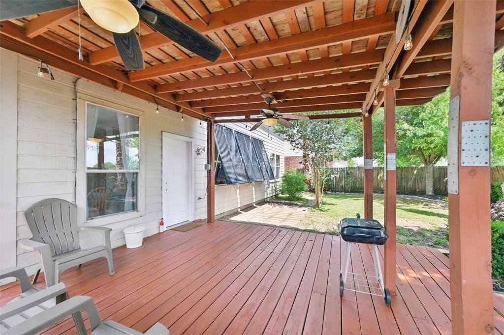 Covered backyard patio perfect for both relaxation and entertaining.