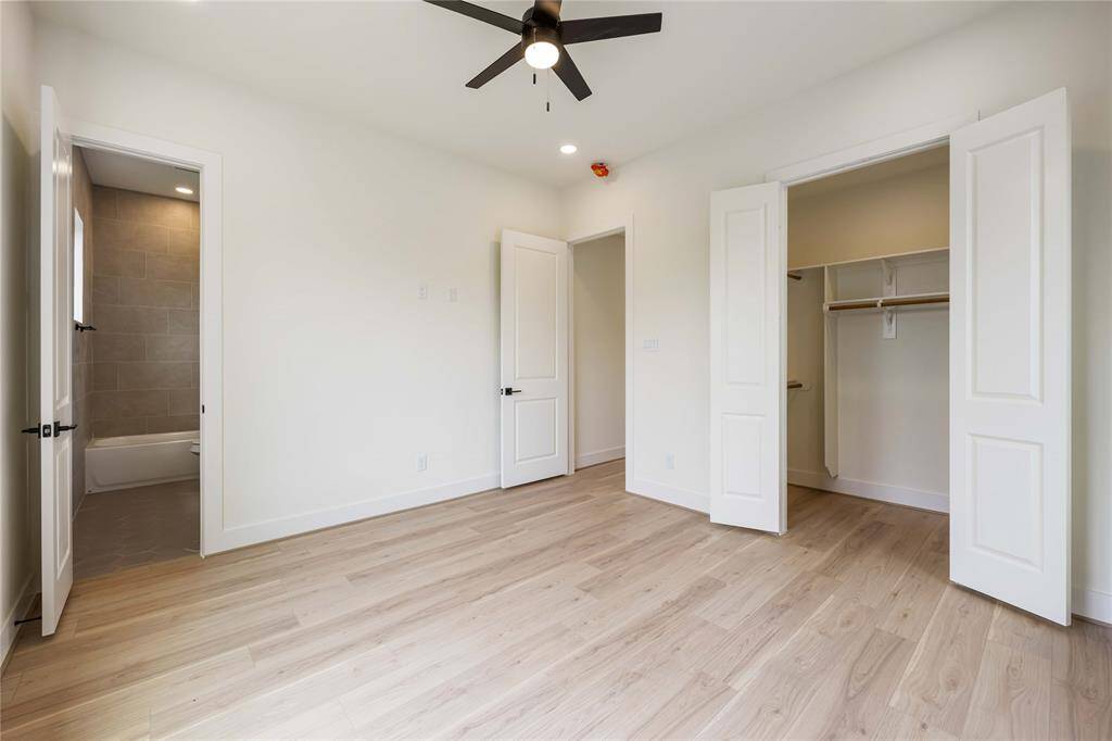 Bedroom 3 from another angle shows a substantial walk-in closet and the entrance to the en-suite bath.