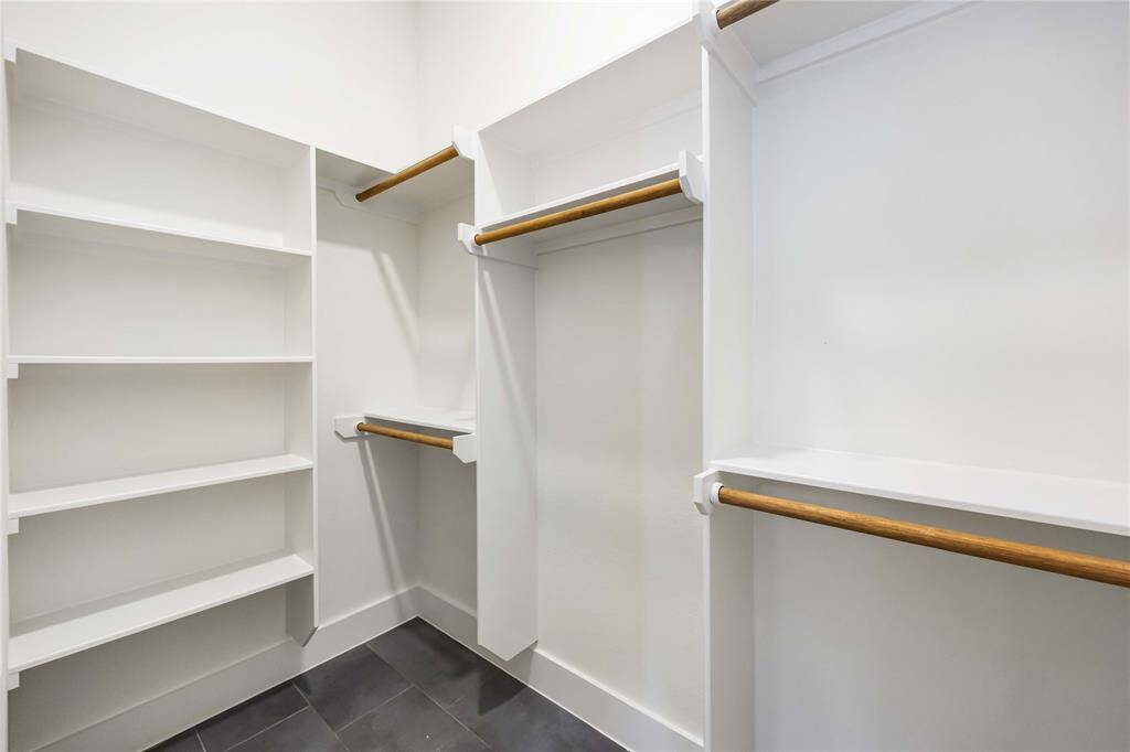 You'll love all the space afforded to you in this closet belonging to the 3rd floor secondary bedroom! Built-in shelves and plenty of room for hanging clothes here.