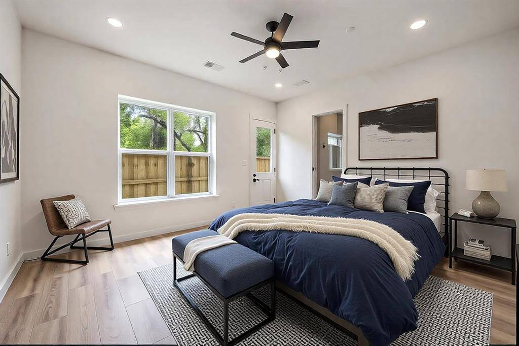 As you enter on the first floor, you'll find this expansive bedroom and en-suite. This is an ideal spot for an office, a library, a workout room, or a guest suite! The door to the backyard provides easy access to some fresh air. *Virtually staged photo