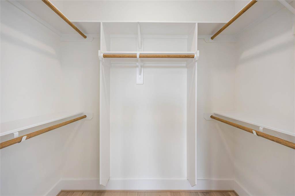 This walk-in closet is located in the 1st-floor bedroom suite.