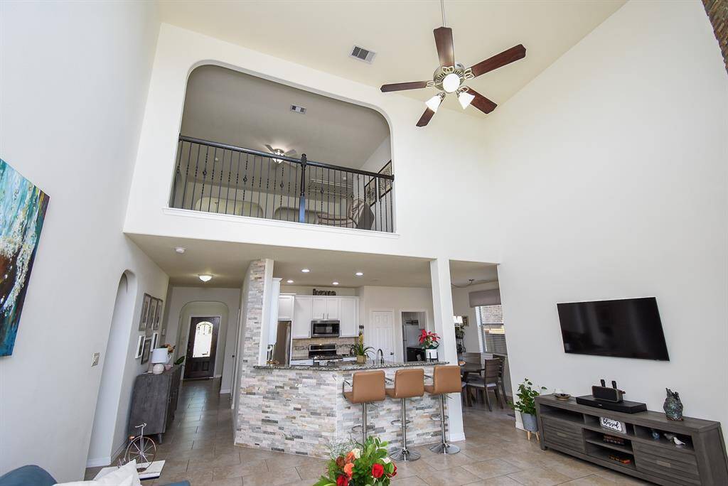 The timeless beauty and versatility of the open floor plan design concept presents tremendous, unobstructed space, up and down, with a clear view from here, straight through to the front door.