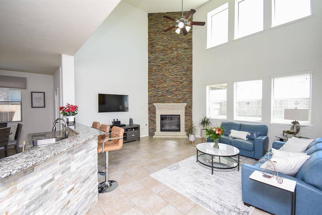 Imagine this showplace at holiday time with family and friends filling this amazing space, gathered round a warm, glowing fire. (The raised granite? quartz? counter top easily accommodates your favorite stools for quick snacking/extra seating when entertaining, perhaps, while providing the perfect surface for your famous finger foods!
