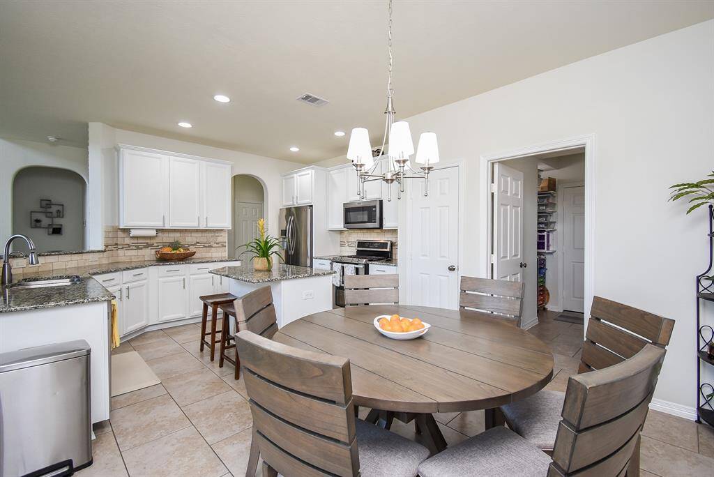 Sizeable pieces are welcomed in this breakfast nook, with a full view of this marvelous kitchen.