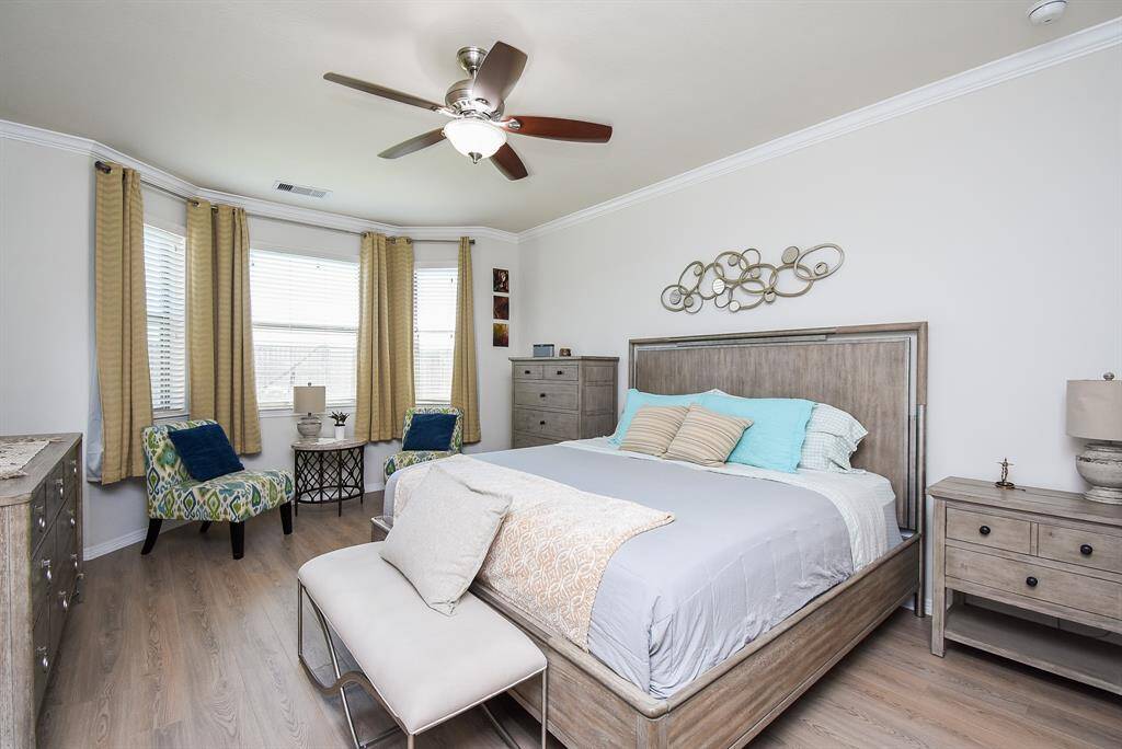 A wall of bay windows brings pure sunshine into your primary suite, with ample room for all your beloved bedroom pieces.