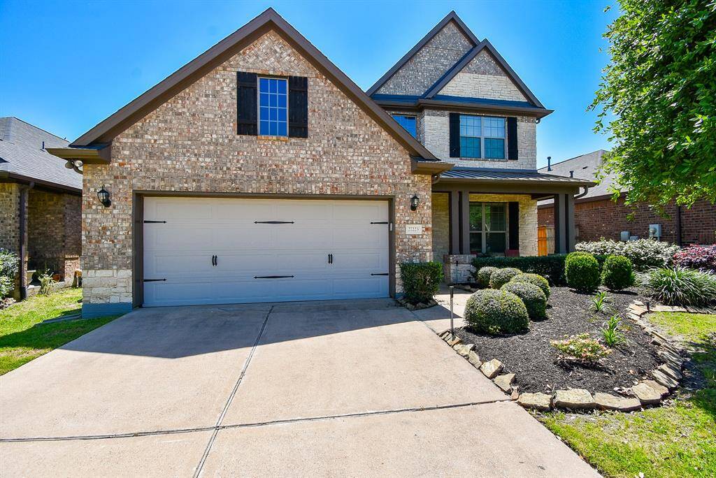 This is an exquisite 2-story brick treasure, enhanced by meticulous landscaping, as seen here. The inviting covered entry/front porch is roomy enough for some seasonal pieces and garden ornaments, too.