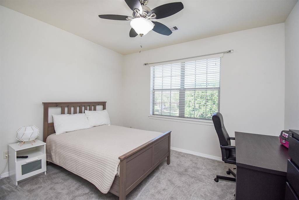 An additional carpeted bedroom is roomy and bright and perfect for family and visiting guests.
