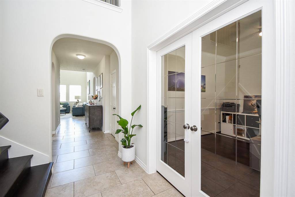 It's the little things in a home like this that make for visual interest and comfort, like a wide, arched doorway leading to the huge living/family area.