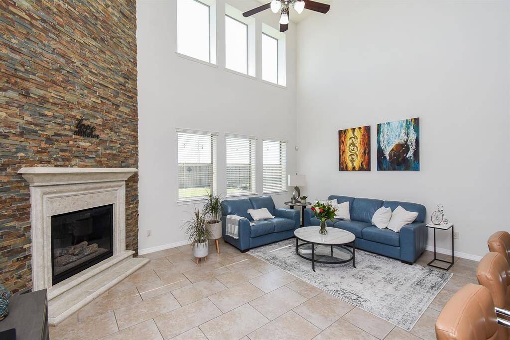 Cathedral like, yet cozy in a contemporary way, your amazing living area features a heavenly high ceiling, an incredible wall of windows, and the star of the show: the brick encased, floor-to-ceiling gas connected fireplace.