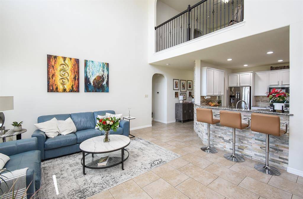 What a complete and satisfying view from living area, kitchen, and a glimpse of the catwalk/railing above on the 2nd 'game room' floor.