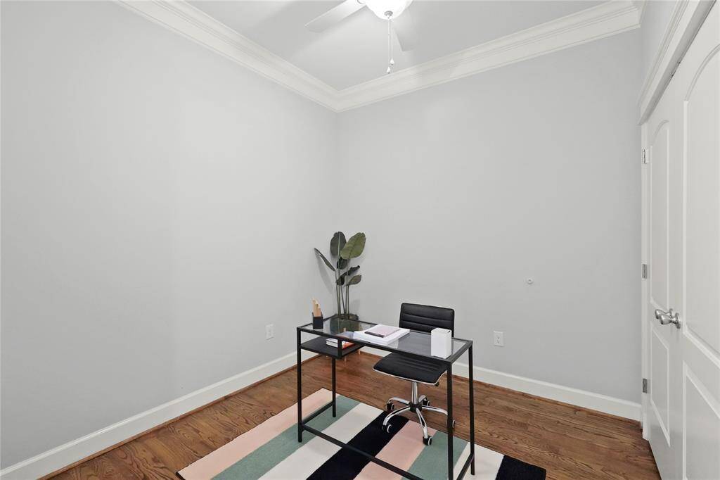 Second bedroom offers crown molding, hardwood floors, and a ceiling fan. Can be used as an office, game room, bedroom, or fitness room