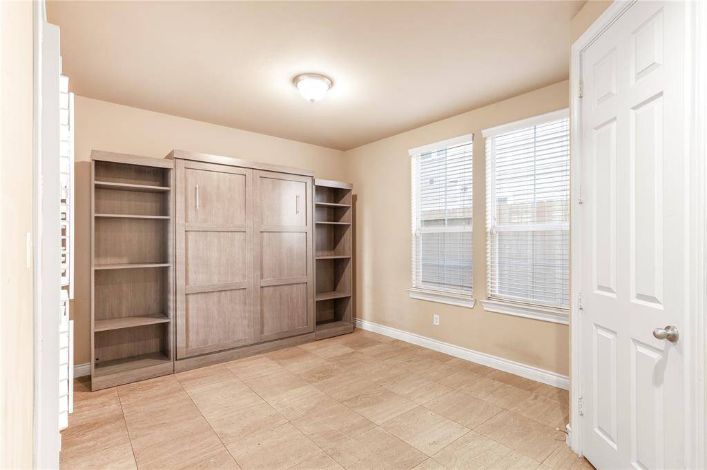 first floor bedroom can be used as a guest room or office with built in shelving and murphy bed!