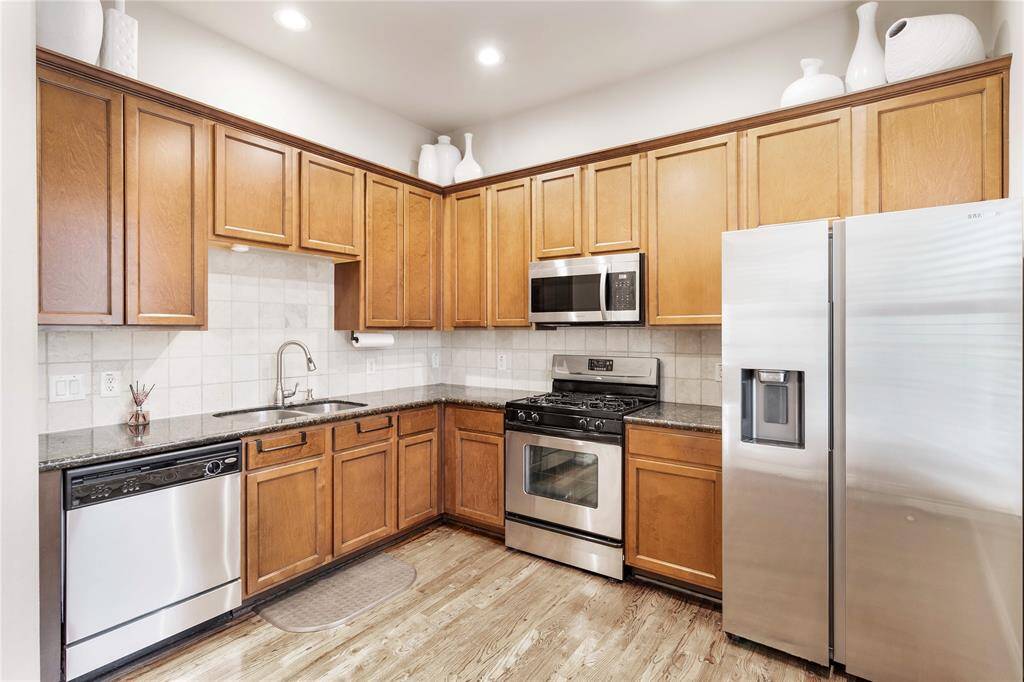 Kitchen features gas range and stainless steel appliances