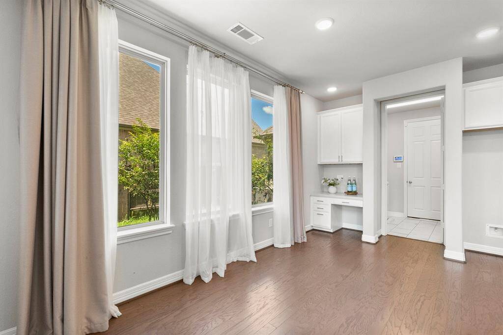 The sunny breakfast area features 3 large windows and a built-in desk