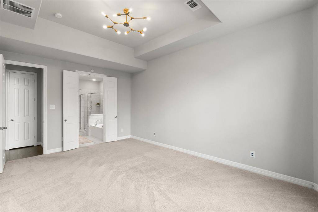 Double doors lead to the luxurious primary bath