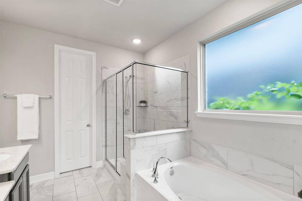 The large privacy window fills the space with natural light