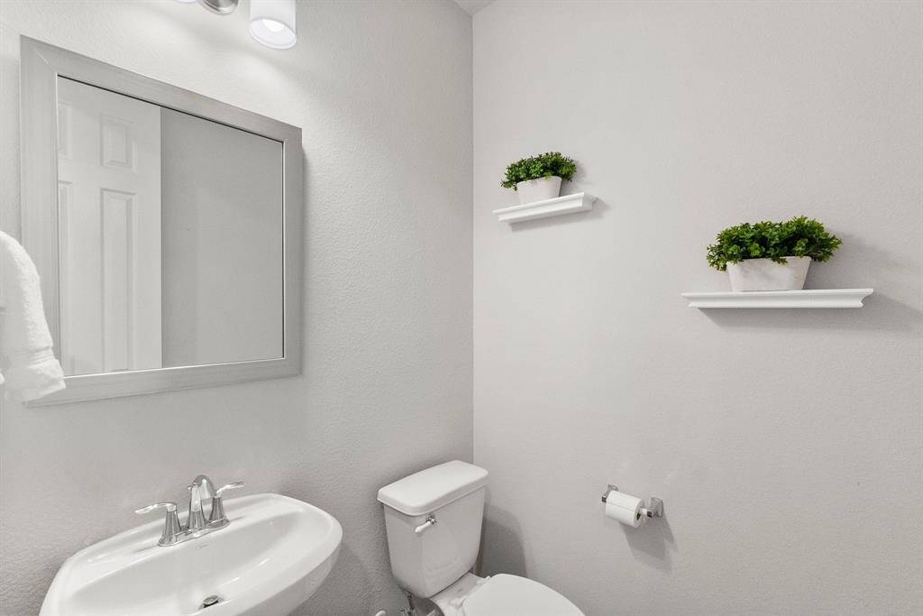 A convenient powder room is located in the downstairs hallway