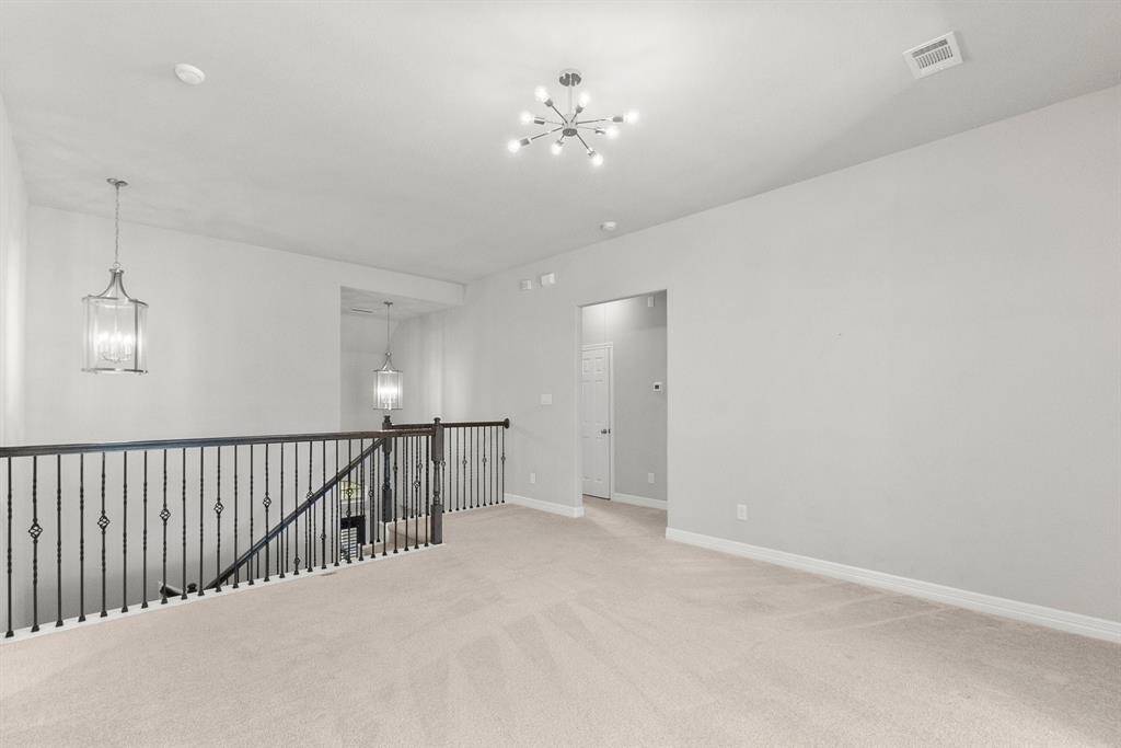 The spacious game room leads to 3 secondary bedrooms and 2 full baths