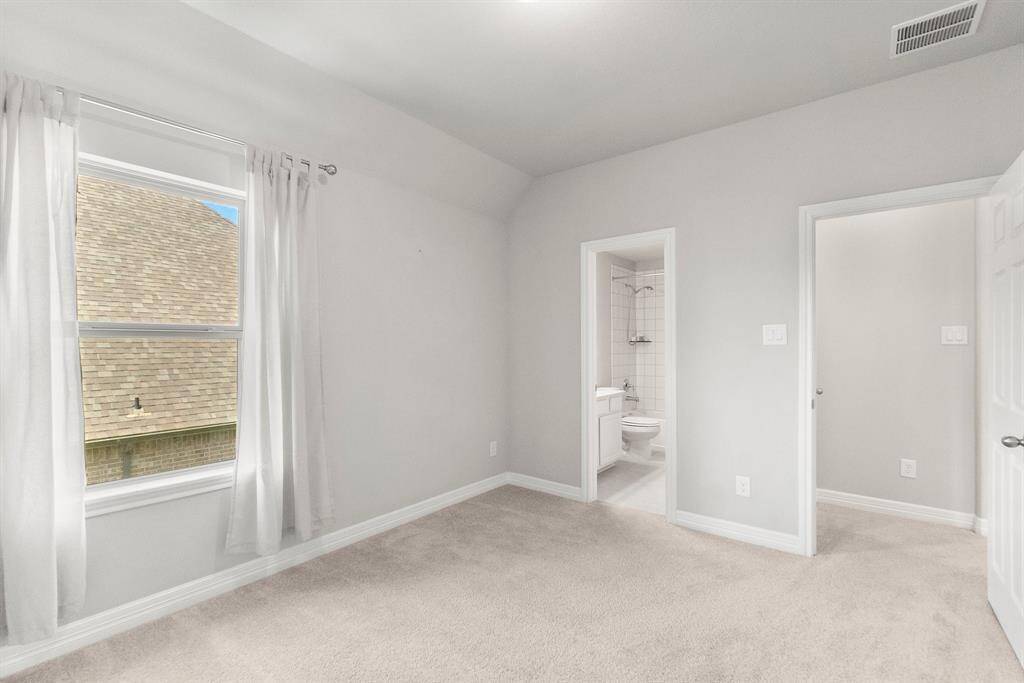 Secondary bedroom number one features an en suite bath
