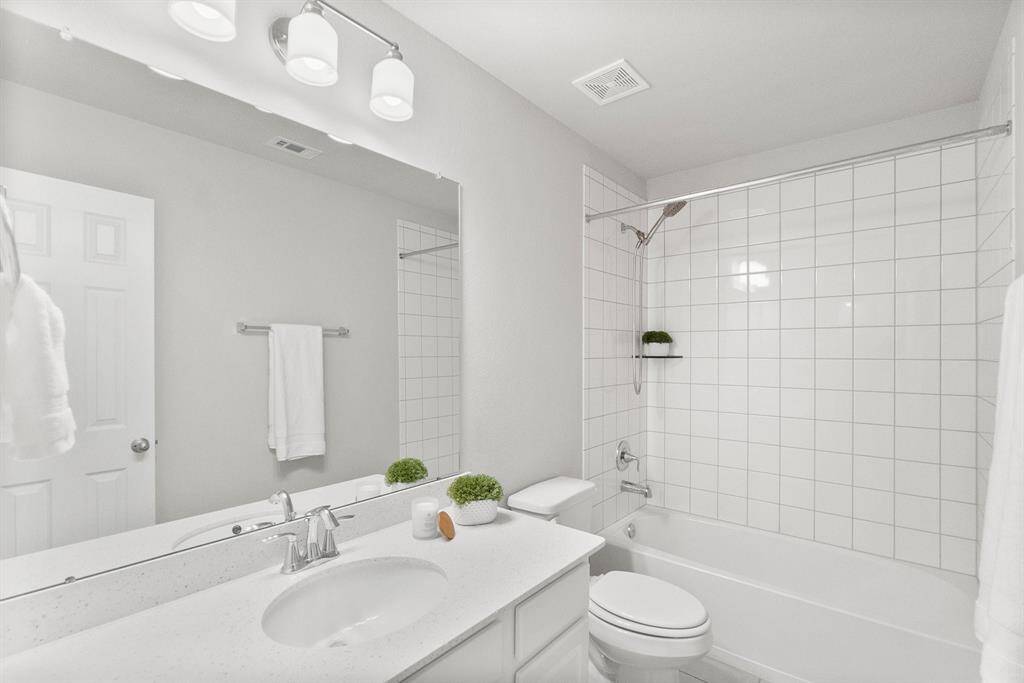 A full bath is situated in the hallway between bedrooms two and three