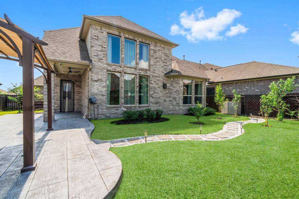 An extended back patio creates the perfect place for enjoying the beautiful backyard
