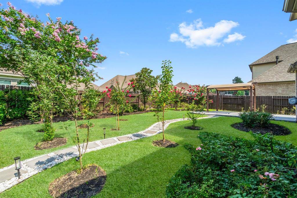 The park-like backyard has been lovingly landscaped by the owners (yard maintenance included)