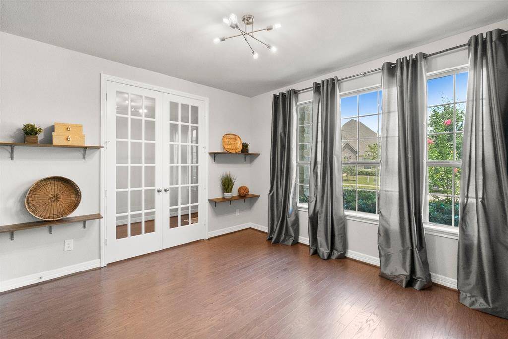 Study features charming wood shelves and 3 large windows overlooking the front yard