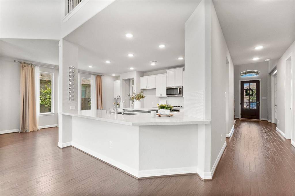The expansive kitchen features a large breakfast bar