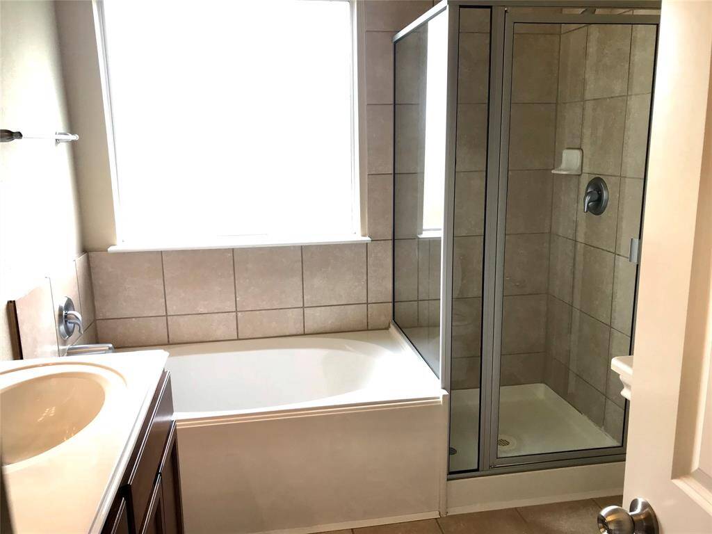 Primary bath with dual sinks, large tub and separate shower.  Large walk in closet too.