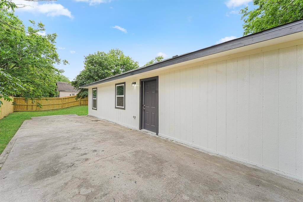 Back porch that has a slab of concrete that is ready for your outdoor dinner parties.* picture some lights, outdoor rug, outdoor table and chairs and a nice grill*