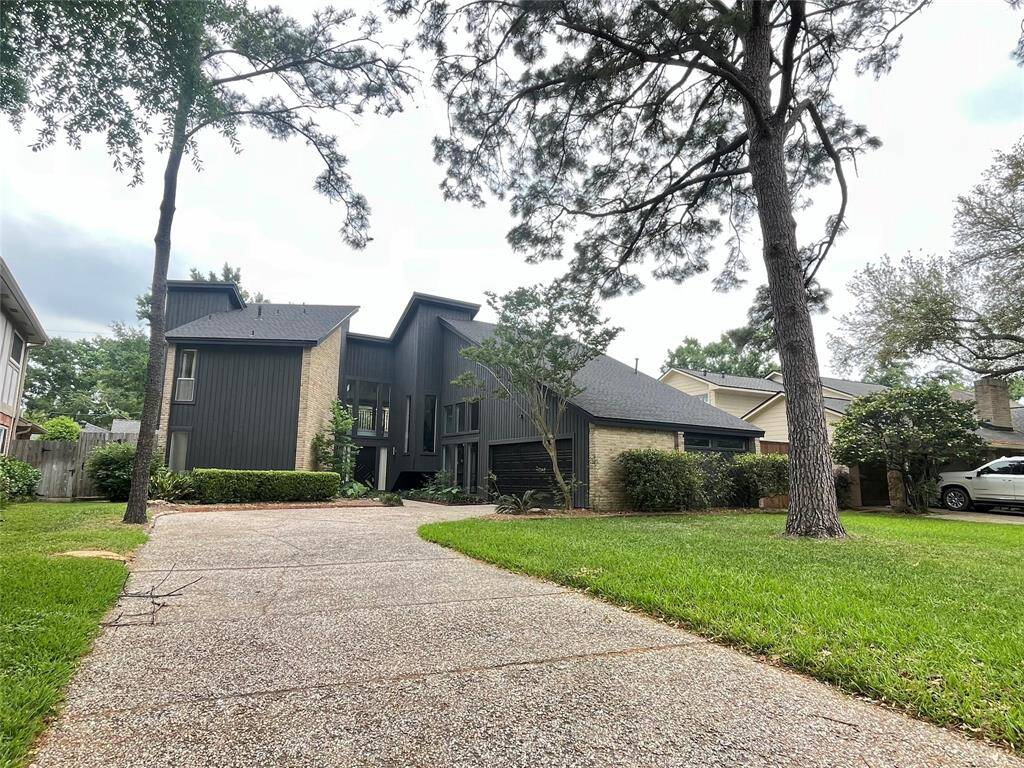 The mature trees give the home setting a park like feel!