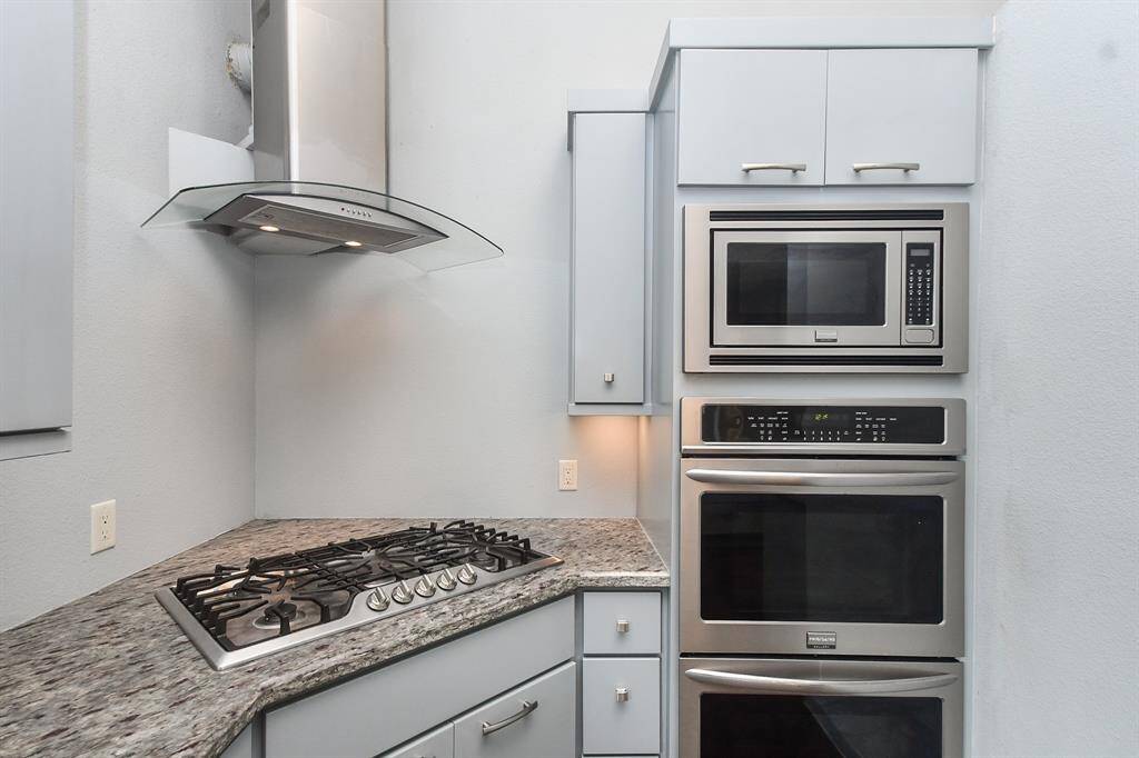 The kitchen has double ovens and microwave.